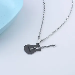 Detailed view of a black guitar pendant necklace on a minimalist gray background