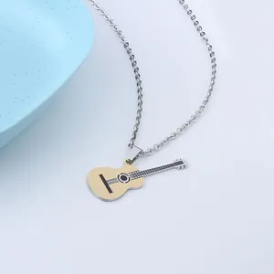 Detail of creative gold and silver guitar pendant necklace with polished music theme design