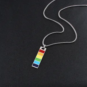 Macro view of a rectangular rainbow enamel pendant on a silver box chain necklace
