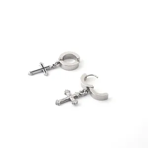 Detailed macro view of stainless steel cross earrings with embossed religious design