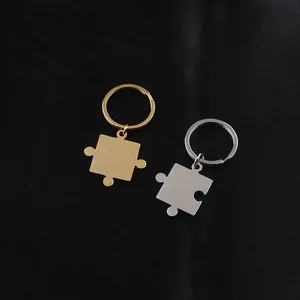 Close-up of interlocking puzzle-shaped king and queen crown keychains in gold and silver
