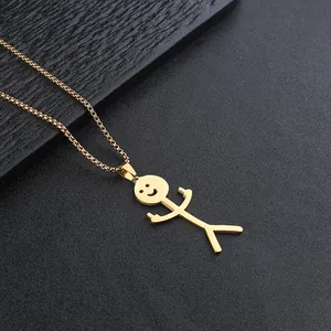 Detailed close-up of golden matchstick man pendant with middle finger on black texture