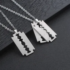 Macro view of stainless steel razor blade pendant necklaces with brushed metal finish