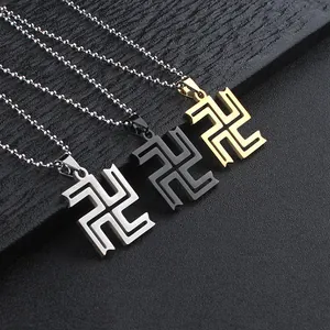Detailed view of three stainless steel cross pendants in silver, gold, and black colors