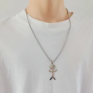 Detail view of a funny stickman pendant necklace on a model with a silver ball chain