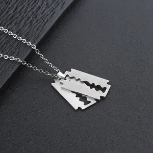 Close-up of industrial punk razor blade pendant with brushed stainless steel finish