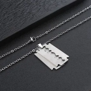 Detail of silver razor blade pendant on a fine link chain made of stainless steel