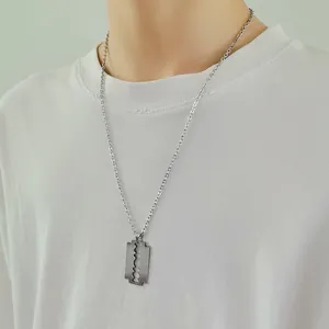 Close-up of silver razor blade pendant necklace in brushed stainless steel finish