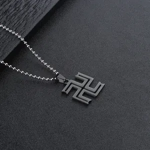 Macro detail of black stainless steel bead chain and geometric pendant with matte finish