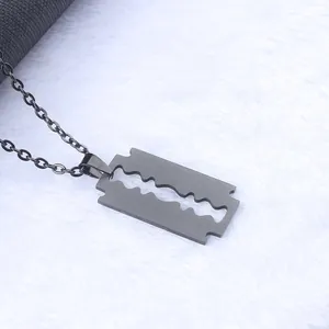 Matte black razor blade pendant necklace in brushed stainless steel on white background