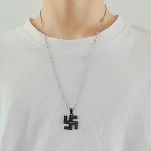 Detail of man wearing black Tokyo Revengers swastika pendant with silver bead chain