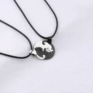 Detail view of interlocking black and white cat pendants with 30*26mm size specifications