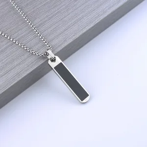 Minimalist silver stainless steel bar necklace for men with black inlay on wooden surface