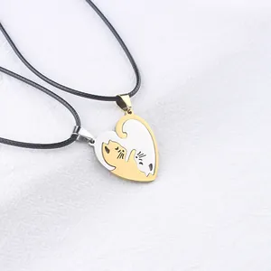 Matching cat heart necklaces in gold and silver finish on white woven texture