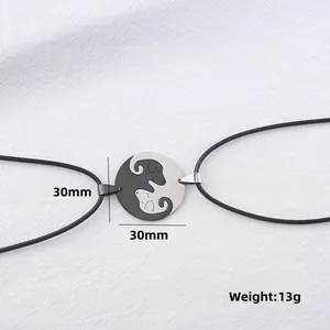 Detail of 30mm yin yang cat puzzle necklaces in black and silver stainless steel