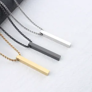 Close-up of gold, black and silver rectangular vertical bar pendants on box chains