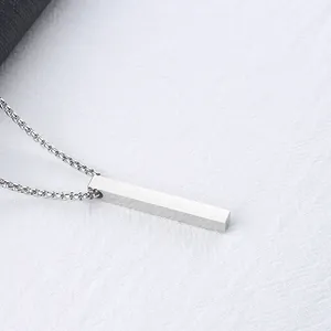 Macro shot of minimalist silver-tone rectangular bar pendant with polished metal finish