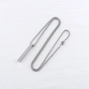 Macro detail of polished stainless steel rectangle pendant with fine box chain link