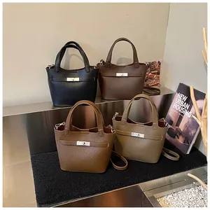 Close-up of litchi grain bucket bags with metal twist locks in four elegant colors