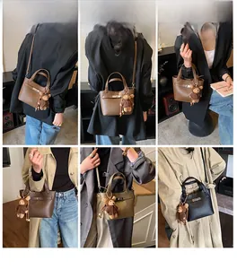 Litchi texture leather bucket bag with metal buckle and teddy bear charm details