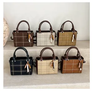 Detail view of stylish quilted tote bags in six colors with decorative wooden bead tassels