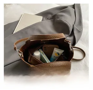 Internal capacity of brown pebble leather bucket bag with inner pouch and personal items