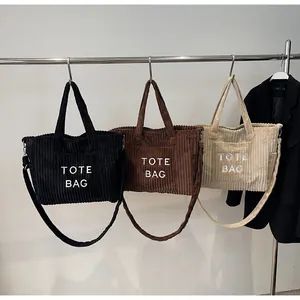 Detailed corduroy texture and front pocket view of large capacity tote bags in three colors