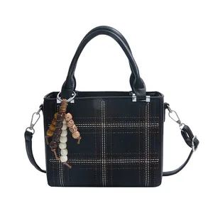 Black checked pattern handbag with wooden bead tassel and adjustable shoulder strap