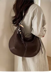 Sac fourre-tout demi-lune en cuir marron foncé avec surpiqûres blanches et charm