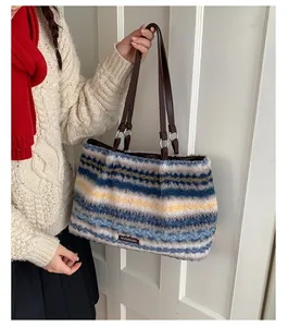Detail of plush striped tote bag featuring soft fleece texture and brown leather strap