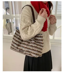 Detail of plush striped tote bag with soft texture and stylish brown leather handle