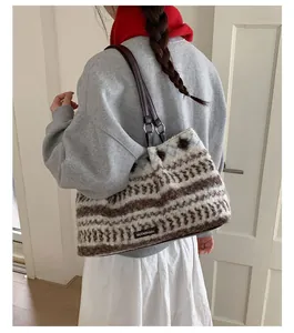 Large striped plush tote bag with vintage knit pattern and brown leather shoulder straps