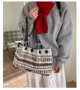 Detail of plush tote bag with striped pattern and premium brown leather shoulder strap