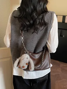 Brown faux leather baguette bag with silver chain and cute plush rabbit charm
