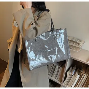 Detailed view of grey canvas tote bag with transparent PVC layer and TOTE BAG print