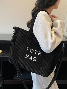 Black corduroy tote bag with TOTE BAG embroidery and adjustable strap for casual commute