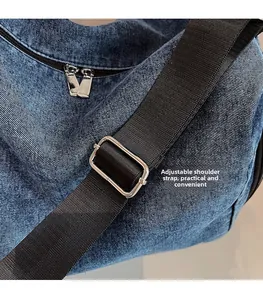 Detail of adjustable nylon strap and silver metal buckle on the denim tote bag
