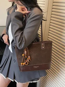 Minimalist vintage dark brown tote bag with beaded tassel and stitching details