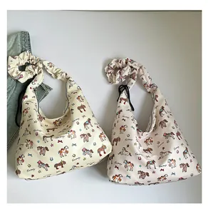 Detail of canvas tote bags featuring colorful cartoon pony prints and ruched shoulder straps