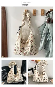 Detail of beige canvas tote with colorful pony print and ruffled pleated handle