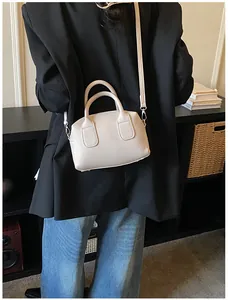 Vue détaillée d'un sac baguette en cuir grainé blanc crème avec sa bandoulière amovible