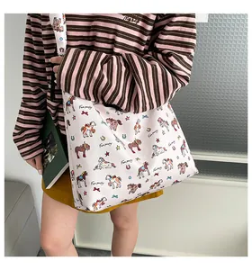 Detail view of canvas tote bag with colorful cartoon pony prints and Fun Party text