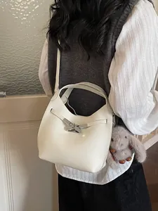 White pebbled leather bucket bag with silver twist lock and cute bunny charm accessory