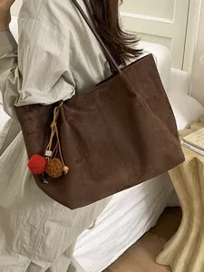 Minimalist large brown suede tote bag for women shown as a stylish shoulder bag