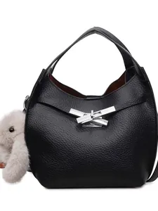 Minimalist black lychee texture bucket bag with silver buckle and plush bunny charm