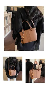 Three-way view of a dark brown litchi textured bucket bag with retro beaded tassel