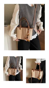 Detail of canvas and PU tote bag with vertical stripes and wooden bead tassel pendant