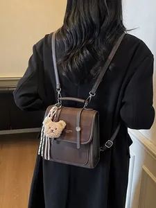 Brown vintage checkered tote backpack with a cute bear charm for a stylish look
