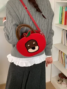 Creative apple-shaped plush handbag with otter embroidery and adjustable shoulder strap