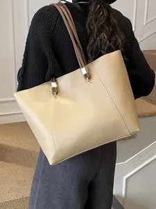Elegant beige tote bag with dark brown straps and gold hardware for daily office wear